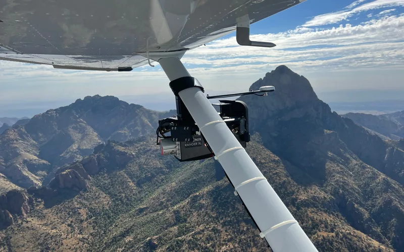 LiDAR sensor pod mounted on a fixed wing strut over mountainous terrain
